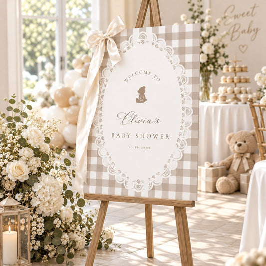 Teddy bear baby shower welcome sign with white lace and beige gingham at a party entrance