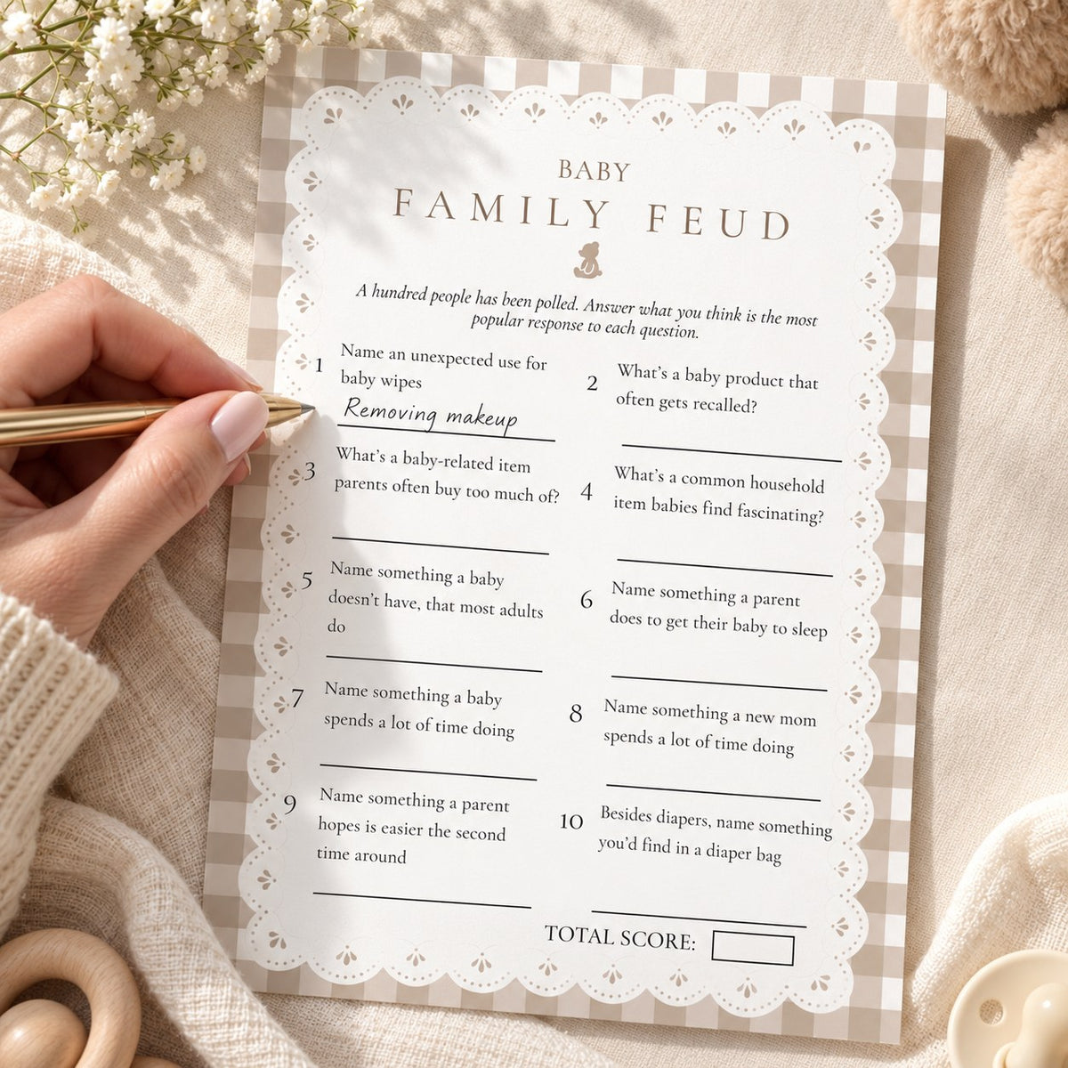 Guest filling in a Baby Family Feud baby shower game card