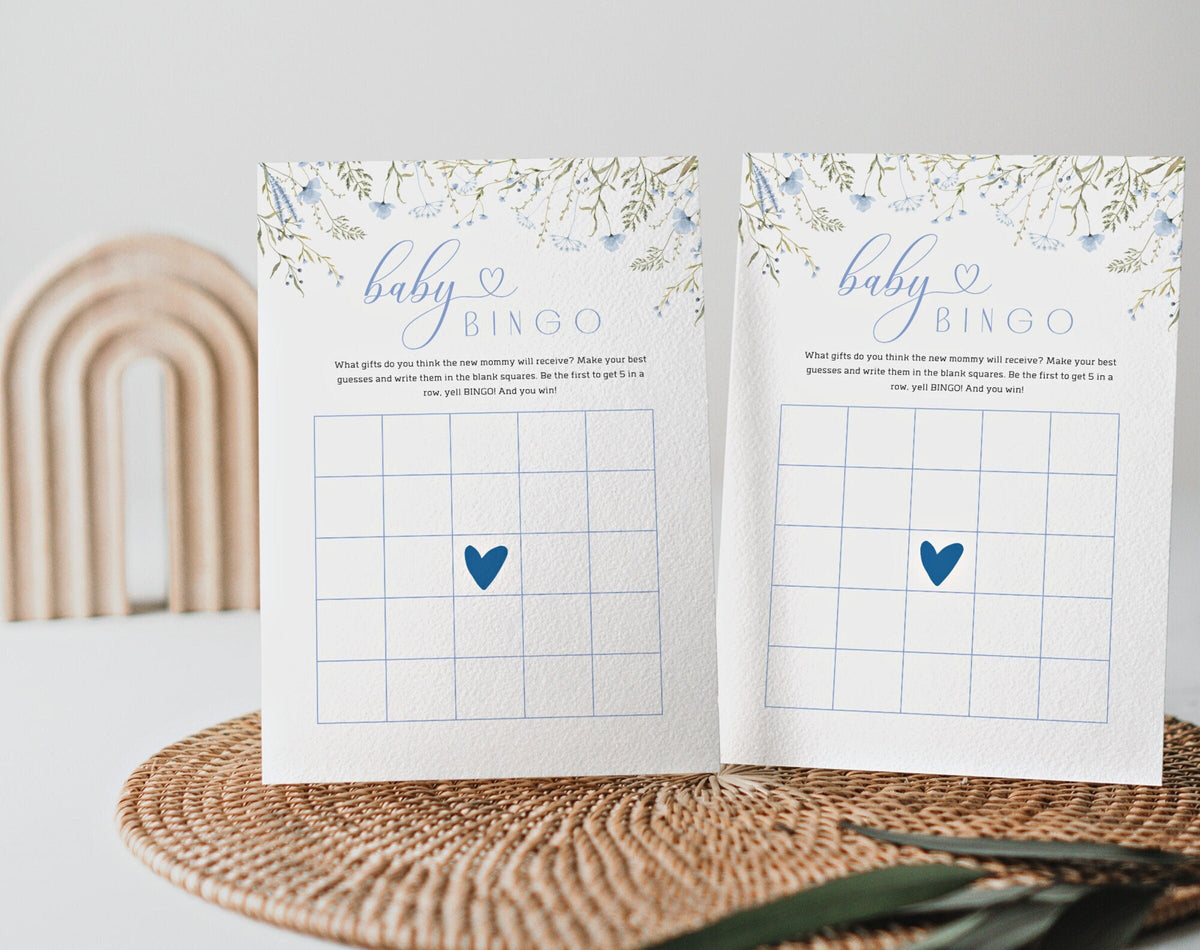 Two blue wildflower baby bingo cards with blank grids and blue heart centers