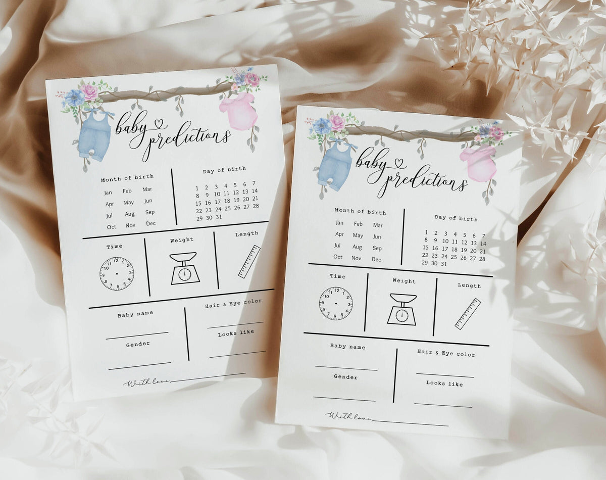 Baby prediction cards with pink and blue outfits hanging from a floral branch