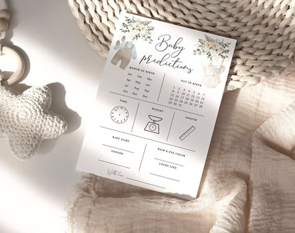 Baby predictions card with blue and cream outfits, greenery and a knitted star