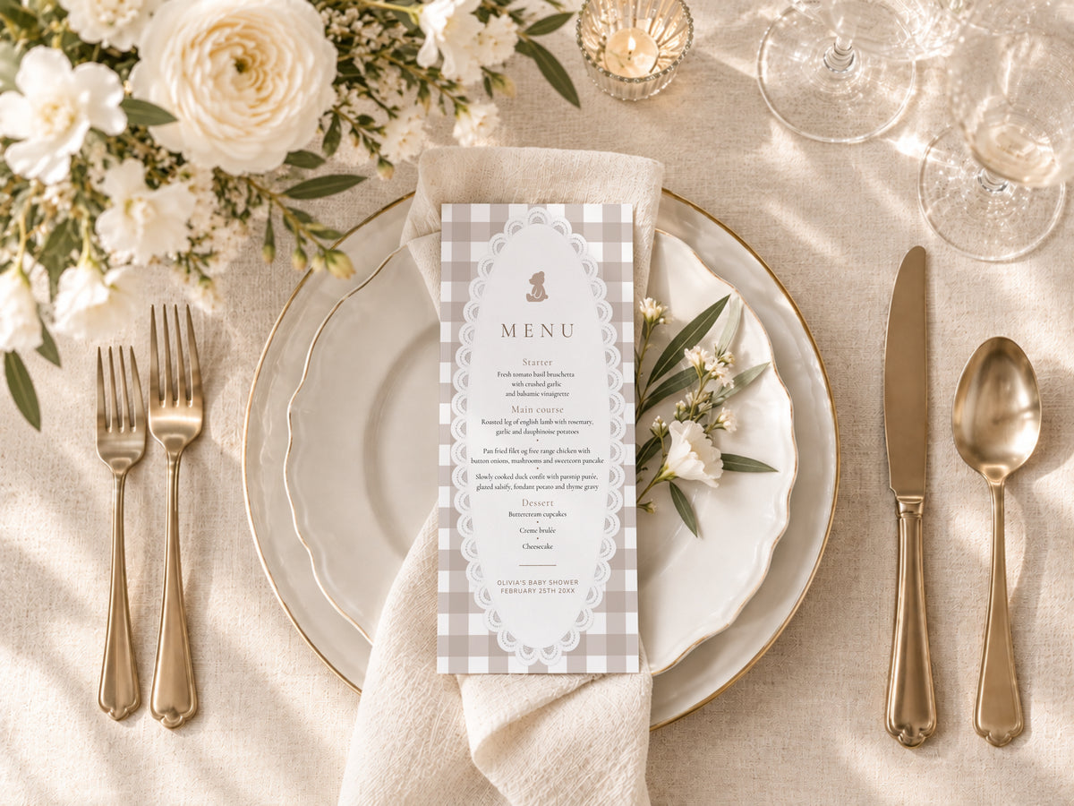 Teddy bear gingham baby shower menu card on a plate with a linen napkin and gold cutlery