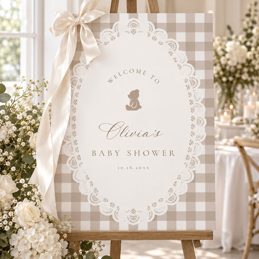 Teddy bear gingham baby shower welcome sign on an easel with a cream bow