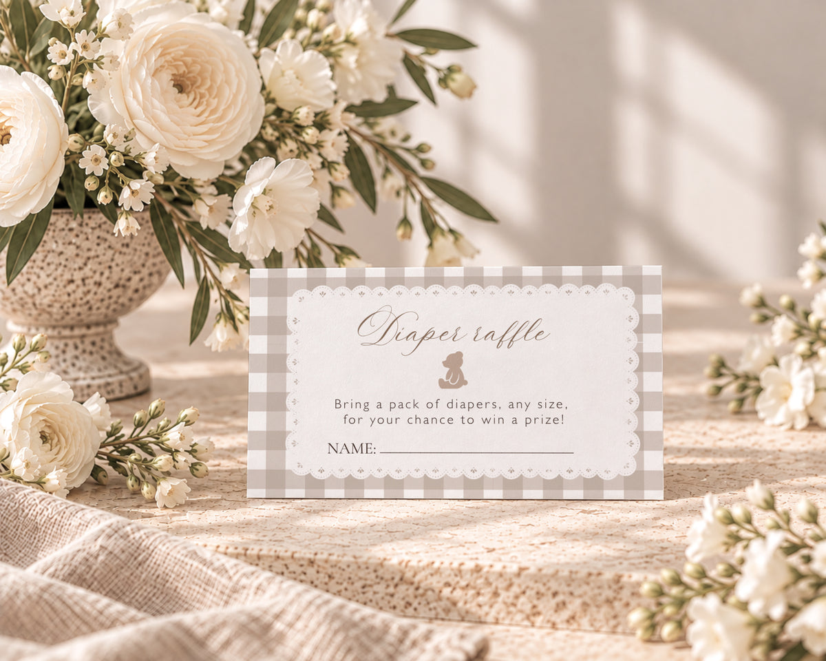 Teddy bear diaper raffle ticket with lace frame and beige gingham next to white flowers